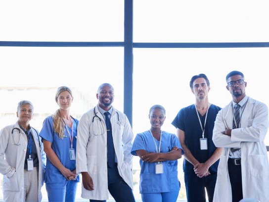 The diverse Trusted Health Focus care team smiling together